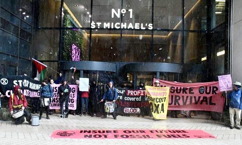 Group of demonstrators outside insurance building with banners and Palestine flags
